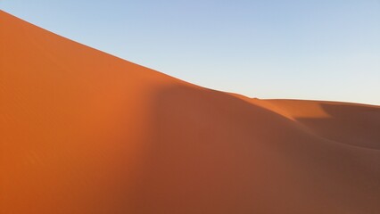 Fototapeta na wymiar sand dunes in the desert on sunset light