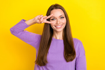 Closeup photo of cute charming good mood woman wear stylish purple pullover toothy smiling cover face v-sign carefree isolated on yellow color background