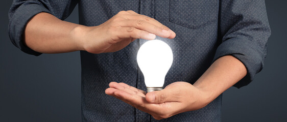 Humans hold light bulbs in hand innovative technology and creativity