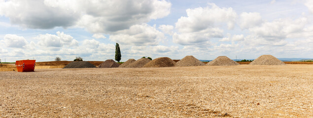 Web Banner Entrance construction site, driveway of building site. Pile of sand and Gravel for...