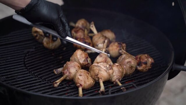 Roasting chicken legs on a grill