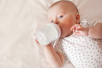 Little cute baby eating formula. Infant feedeng