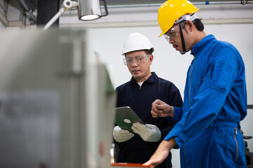 experienced operator technician worker or engineer metalworker industrial in safety helmet working...