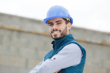 man builder in a helmet smiles