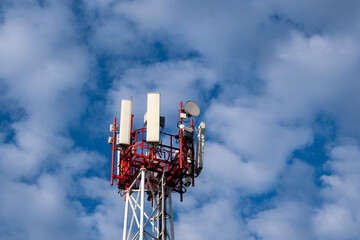 The top of the tower of a mobile operator. Communication antennas on the tower.