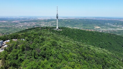 Aerial of the Avala tower in the middle of a green hill in Beli Potok, Serbia.
