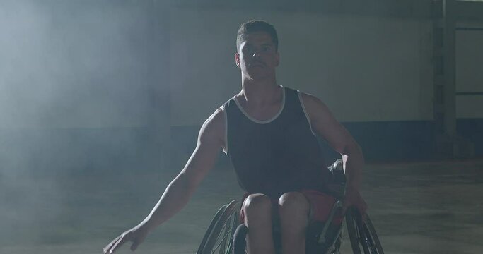 Portrait of a Brazilian paraplegic disabled athlete on wheelchair playing basketball inside sport court looking at camera