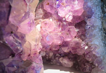 Raw violet Amethyst quartz crystal cave close-up