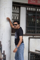 guy wearing black clothes infront of old building