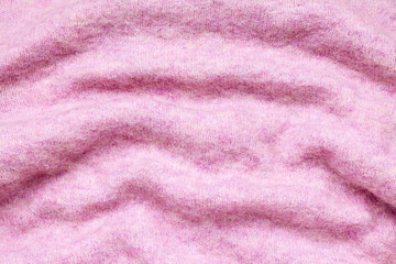Fototapeta na wymiar Close-up abstract texture pink color fabric cloth textile background, knitted wool wavy material, soft folds waves on the fabric. Macro, web theme, template, wallpaper, concept design