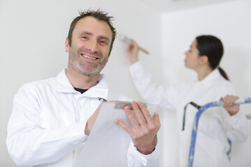 happy painter worker on clipboard