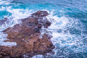 Water of the Atlantic Ocean breaking over rocks - water breaking on rocks