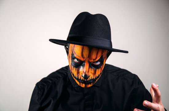 halloween witch with pumpkin. Halloween face. Evil. Man brutal face. Background. Male. 