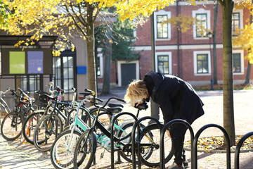 Obraz premium young man walking in the park, riding a bicycle on a warm sunny autumn day