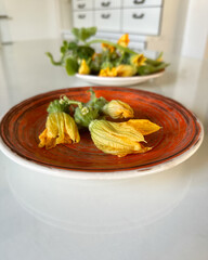 Fresh flowers of a small decorative pumpkin. Fried pumpkin flower as summer appetizers.