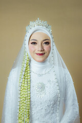 beautiful model, wearing hijab, Javanese Indonesian wedding dress in an indoor photography studio, with Javanese wedding dress attributes