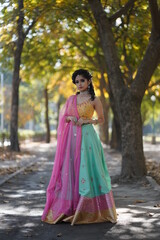 Fototapeta premium beautiful girl wearing red dress posing in park