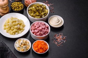 Delicious fresh Olivier salad with sausage, egg, cucumber, green peas, carrots and mayonnaise