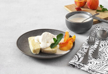 Lazy dumplings, vareniki with fresh sour cream and pieces of peach. copy space