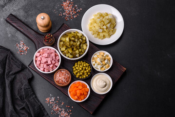 Delicious fresh Olivier salad with sausage, egg, cucumber, green peas, carrots and mayonnaise