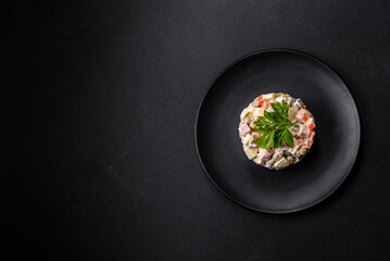 Delicious fresh Olivier salad with sausage, egg, cucumber, green peas, carrots and mayonnaise