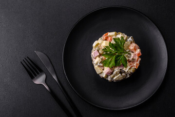 Delicious fresh Olivier salad with sausage, egg, cucumber, green peas, carrots and mayonnaise