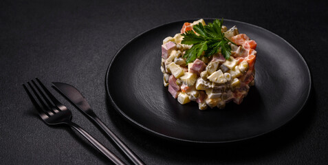 Delicious fresh Olivier salad with sausage, egg, cucumber, green peas, carrots and mayonnaise