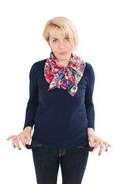 Woman shows the empty pants pockets. Isolated on white background. Studio shot
