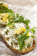 Toast with cream cheese, arugula salad and boiled egg