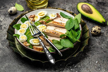 Ketogenic diet food, chicken fillet, quail eggs, avocado, spinach, walnut. healthy meal concept on a light background, banner, menu, recipe place for text, top view