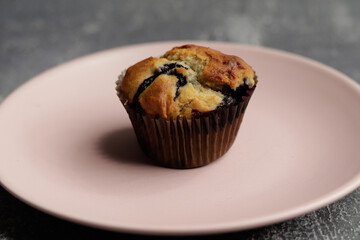 blue berry muffins on a pink plate