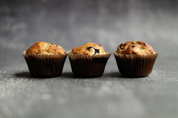 frontal view of 3 blueberry cupcakes