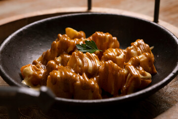 Patatas bravas. Spicy potatoes. Recipe for baked potatoes cooked in the oven with spicy sauce.