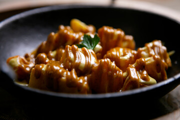 Patatas bravas. Spicy potatoes. Recipe for baked potatoes cooked in the oven with spicy sauce.
