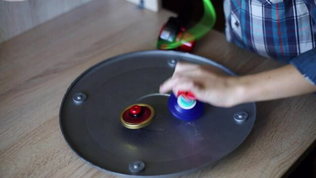A child plays Infiniti Nado. Hobbies, leisure, games. Hands close-up.