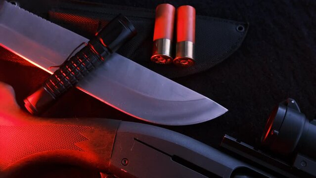 Weapon on black cloth: flashlight, knife, rifle, 