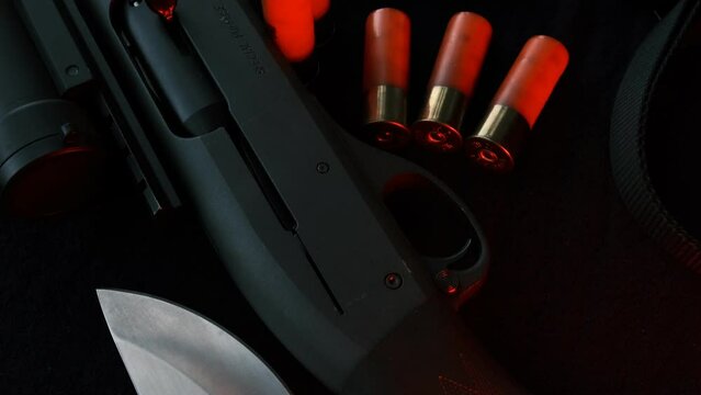 Weapon on black cloth: flashlight, knife, rifle, 