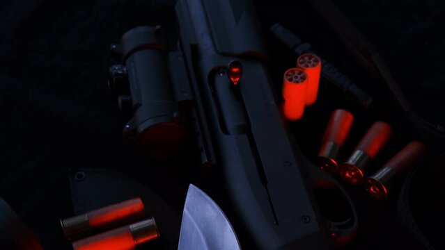 Weapon on black cloth: binoculars, flashlight,