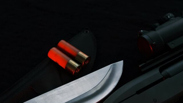 Weapon on black cloth: knife, rifle, shells,top 