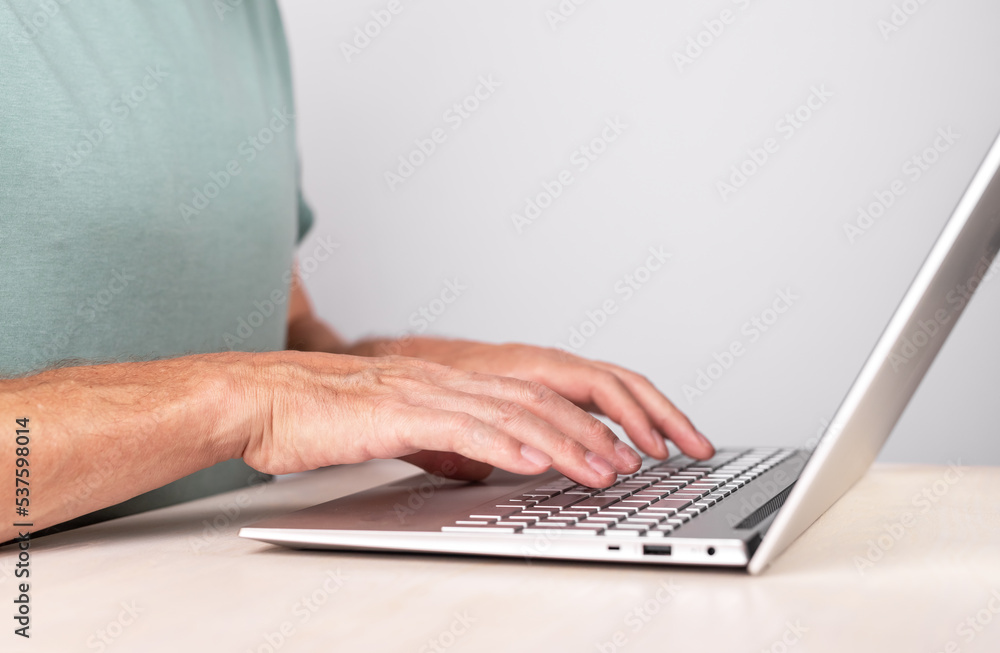 Poster Hands typing on laptop keyboard, pc closeup. Information input concept