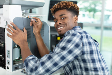concentrated man fixing a printer