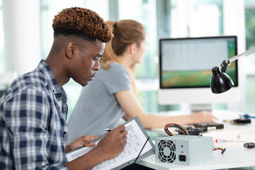 students preparing a pc for testing in workshop