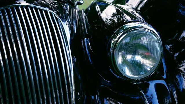 Vintage classic car side view in car headlamps grill