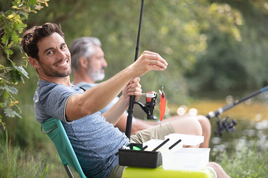 man feeling happ while fishing with dad