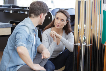 a couple talking at a snooker store