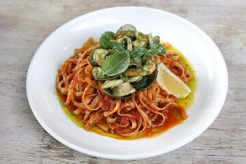 Fettucine Ai Frutti Di Mare pasta noodles served in a dish isolated on grey background side view