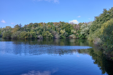The beginning of the beautiful autumn colors, with a blue sky at the lake
