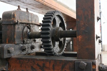 The toothed wheel is part of the drive transmission in the old, manual mangle.