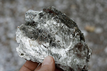 Macro photography of unprocessed pieces of mica minerals in a natural deposit.