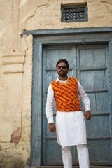 boy wearing old clothes infront of vintage building